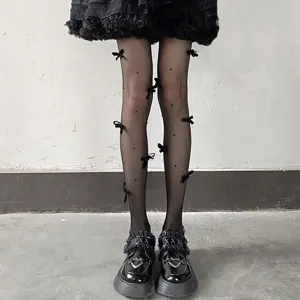 Japanese lolita black sheer tights with cute bows and pearls, detailed shot for sweet style.