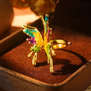 Close-up of a vintage 3D butterfly ring with colorful rainbow enamel finish.