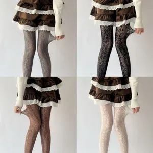 French retro vine hollow-out lace tights detailed view, elastic pantyhose fabric close up.