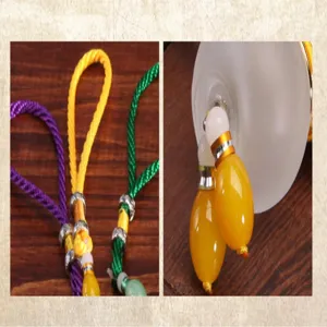 Detailed view of the perfume gourd car pendant featuring colorful braided cords and charms.