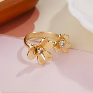 Macro detail of elegant gold double flower open ring featuring sparkling center stones
