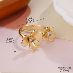 Detailed view of gold-colored floral open ring with crystal centers and dimensions