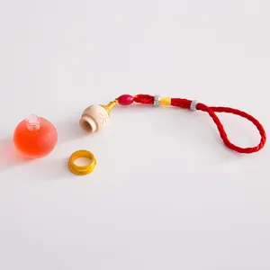 Car aromatherapy essential oil perfume bottle pendant with red braided rope and frosted glass.
