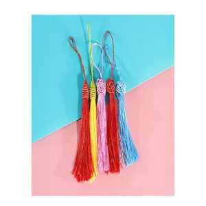 Vibrant colorful craft tassels for bookmarks and DIY projects, featuring delicate threads and loops.