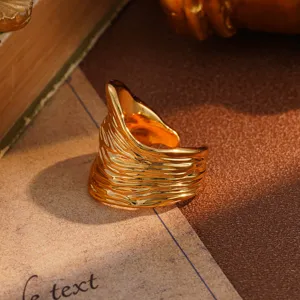 Macro view of vintage gold ring with textured ripple pattern on retro background