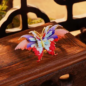 Vue détaillée d'un bijou papillon en émail coloré fait main de style oriental traditionnel.