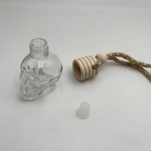 Clear glass skull car perfume bottle empty glass bottle with wooden cap and hanging rope.