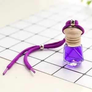 Car perfume bottle detail view, purple liquid crystal glass, wooden cap and hanging rope.