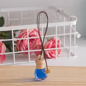 Car perfume bottle pendant with wooden cap and hanging cord, crystal glass diffuser detail view.