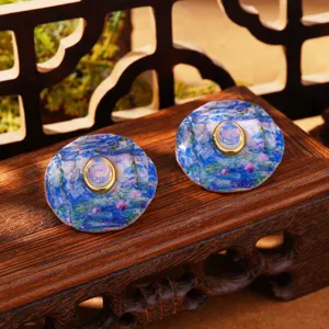 Detail view of Monet Water Lilies inspired enamel earrings with central moonstone inlay