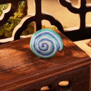 Detail of French vintage enamel earring featuring a Monet-style spiral pattern