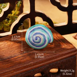 Detailed macro view of Monet style spiral enamel earrings with dimension and weight