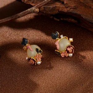 Close-up detail of Chinese style enamel flower earrings with jade-like beads.