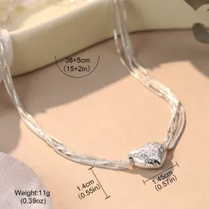 Close-up detail of silver heart pendant necklace with precise dimension and weight labels