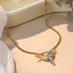 Detailed view of elegant gold angel wings necklace with silver textured pendant design