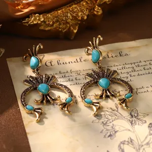 Detailed macro shot of vintage French palace style gold earrings with turquoise stones
