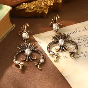 Detailed view of vintage French palace style golden earrings with elegant white pearl inlays