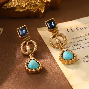 Macro view of vintage French court style earrings with turquoise and blue gems