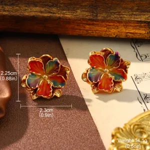 Macro view of colorful enamel flower earrings with gold finish in a vintage palace style