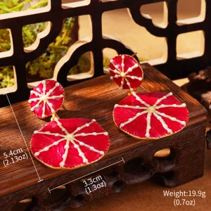 Detail view of Monet-inspired red enamel water lily earrings with size dimensions
