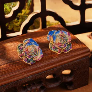 Detailed macro view of French vintage Monet-style enamel flower earrings with gold edges