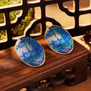 Detailed view of Monet's Water Lilies oil painting pattern on enamel oval earrings.