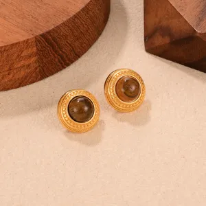 Detail of vintage tiger eye stud earrings with textured gold frame and 925 silver needles.