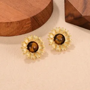 Macro view showing the intricate detail of vintage sunflower earrings with tiger eye stone