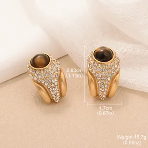 Detailed view of vintage golden tiger eye earrings with sparkling crystal pave accents