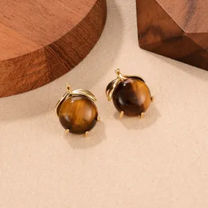 Macro view showing the textures of tiger eye stone and gold leaf earring details