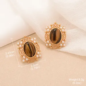 Vintage gold-tone tiger eye earrings with pearl sunburst details, measuring 2.45cm x 2.0cm.