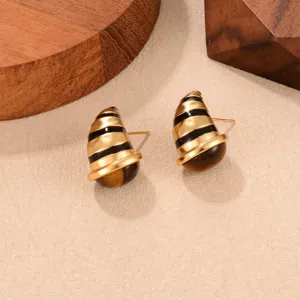 Detailed macro view of vintage Maillard-style C-shaped earrings with tiger eye stone