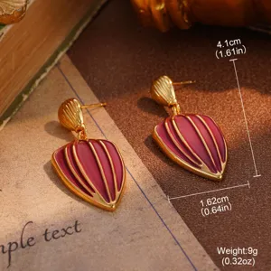 Detailed view of vintage red enamel heart drop earrings with gold-toned striped lines