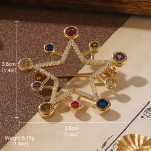 Detailed view of vintage gold star brooch with colorful stones and dimensions
