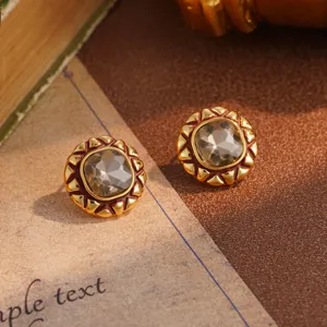 Detailed macro view of vintage gold flower stud earrings with a faceted champagne crystal