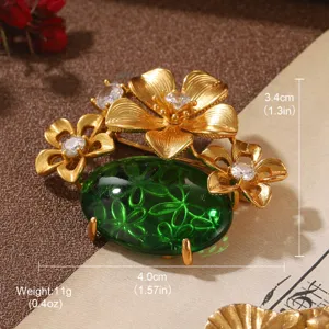 Detailed view of a vintage gold floral brooch with a patterned green stone and size info