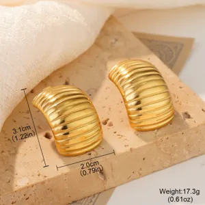Detailed close-up of chunky gold ribbed conch stud earrings with clear size markings.