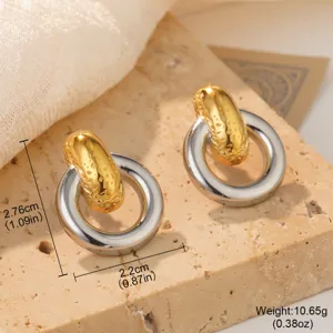Detailed view of two-tone stainless steel hoop earrings with conch texture and dimensions.