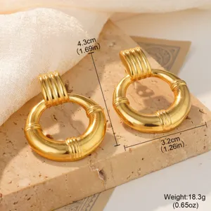 Detailed view of golden conch-style stainless steel hoop earrings showing dimensions.