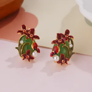 Detailed view of vintage enamel flower earrings featuring green stone and pearls