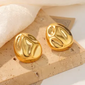 Close-up view of golden textured stainless steel chunky sea shell stud earrings