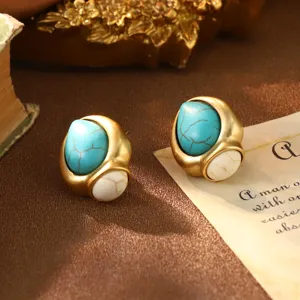 Detail shot of vintage gold-tone turquoise earrings with elegant French court style.