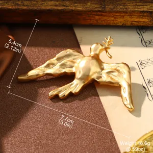 Detailed macro view of vintage golden bird brooch with metric and imperial measurements