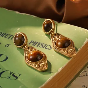 Detailed macro view of vintage French court style drop earrings with brown tiger eye stone