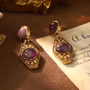 Detailed view of vintage French court style earrings with purple gemstones