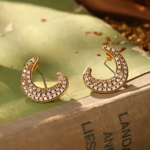 Vue détaillée de boucles d'oreilles vintage en forme de lune dorée avec pavé