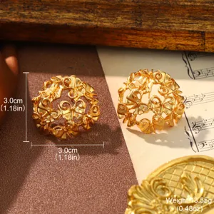 Detailed macro shot of vintage gold filigree stud earrings with intricate ribbon bow motifs