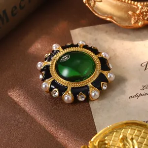 Vintage green emerald cabochon brooch with pearls and rhinestones luxury detail view