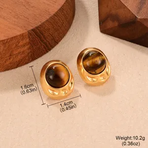 Macro view of vintage gold stud earrings with tiger eye stones and size markings