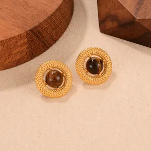 Close-up of vintage French style stud earrings with Tiger's Eye stones and gold-tone finish.
